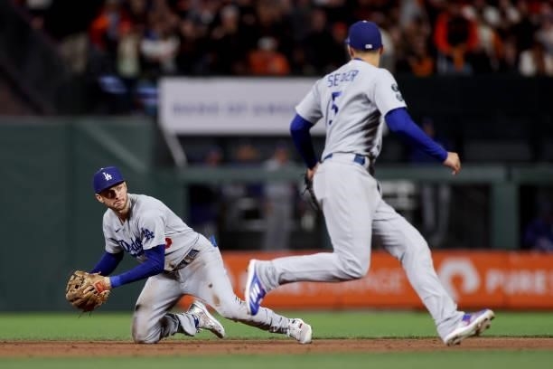 Trea Turner of the Los Angeles Dodgers fields a ground ball as Corey Seager covers second base in the sixth inning against the San Francisco Giants...