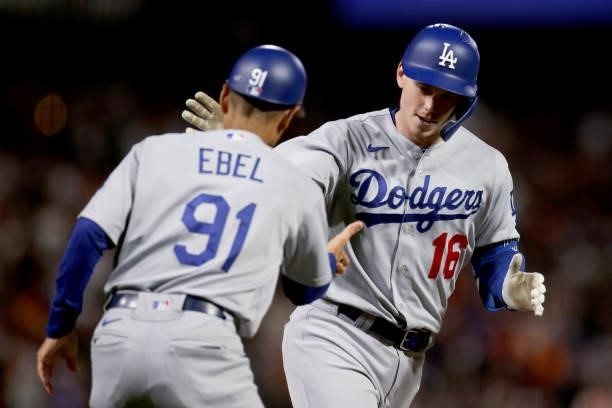 Third base coach Dino Ebel and Will Smith of the Los Angeles Dodgers celebrate as Smith rounds the bases after hitting a home run in the eighth...