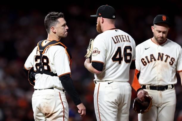 Buster Posey and Zack Littell meet at the mound in the eighth inning against the Los Angeles Dodgers during Game 2 of the National League Division...