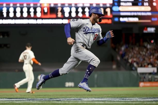Chris Taylor of the Los Angeles Dodgers runs to home plate to score a run in the eighth inning against the San Francisco Giants during Game 2 of the...