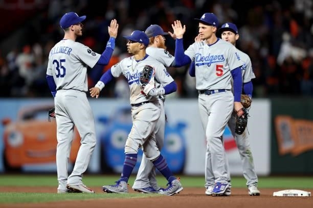 The Los Angeles Dodgers celebrate after beating the San Francisco Giants 9-2 in Game 2 of the National League Division Series at Oracle Park on...