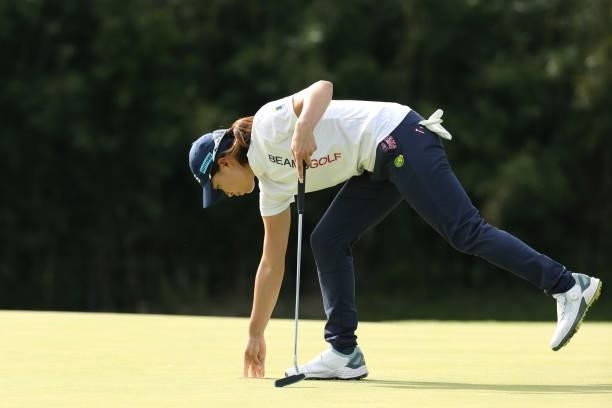 Hinako Shibuno of Japan picks the ball up after the birdie on the 14th green during the final round of the Stanley Ladies at Tomei Country Club on...