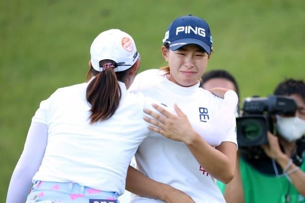 Hinako Shibuno of Japan sheds tears as she is congratulated by Seonwoo Bae of South Korea after winning the tournament through the playoff following...