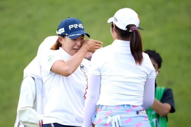 Hinako Shibuno of Japan wipes tears as she is congratulated by Seonwoo Bae of South Korea after winning the tournament through the playoff following...