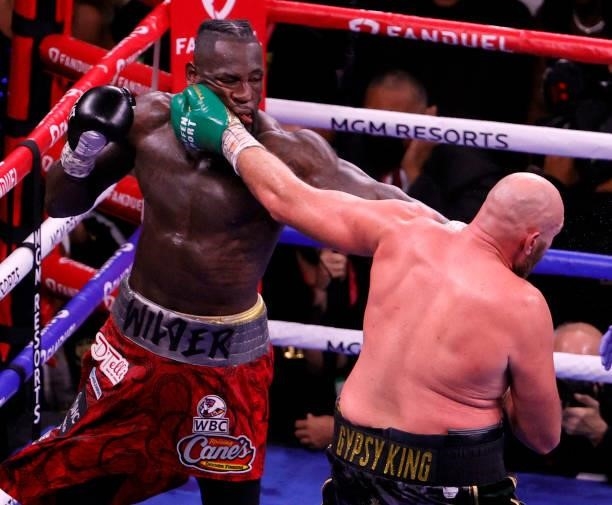 Tyson Fury hits Deontay Wilder in the 10th round of their WBC heavyweight title fight at T-Mobile Arena on October 9, 2021 in Las Vegas, Nevada. Fury...