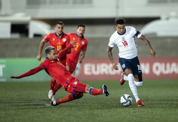 Jesse Lingard of England runs with the ball past the tackle of Marc Vales of Andorra during the 2022 FIFA World Cup Qualifier match between Andorra...