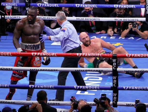 Referee Russell Mora moves Deontay Wilder away from Tyson Fury after Wilder knocked Fury down in the fourth round of their WBC heavyweight title...