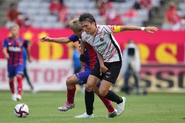 Kensuke NAGAI of FC Tokyo and Shinnosuke NAKATANI of Nagoya Grampus battle for the ball during the J.League Levain Cup Semi Final second leg match...