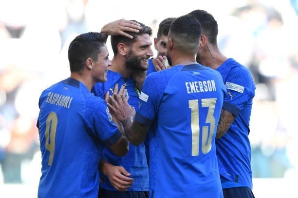 Domenico Berardi of Italy celebrates with Giacomo Raspadori and teammates after scoring their side's second goal from the penalty spot during the...