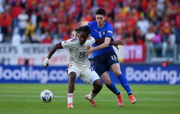 Michy Batshuayi of Belgium holds off Alessandro Bastoni of Italy during the UEFA Nations League 2021 Third Place Match between Italy and Belgium at...