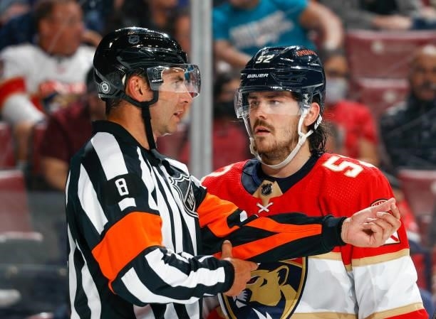 MacKenzie Weegar of the Florida Panthers discusses a call with Referee Francois St. Laurent during second period action against the Tampa Bay...
