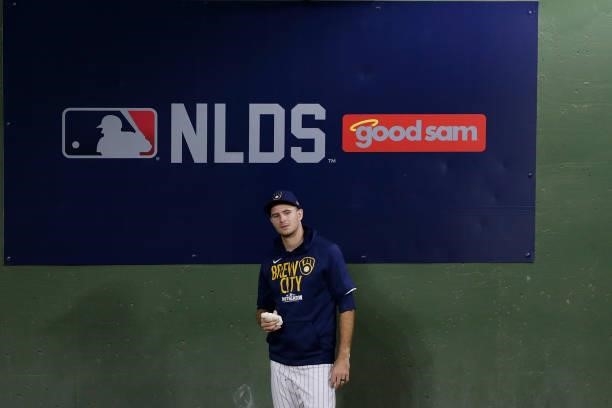 Brewers pitcher stands in front of the NLDS logo in the bullpen during game 2 of the National League Division Series at American Family Field on...