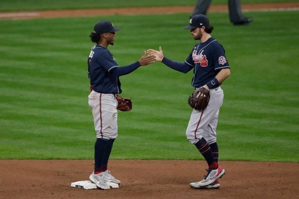 Dansby Swanson of the Atlanta Braves celebrates with teammates after game 2 of the National League Division Series at American Family Field on...