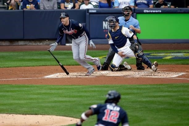 Freddie Freeman of the Atlanta Braves singles in a run during game 2 of the National League Division Series at American Family Field on October 09,...