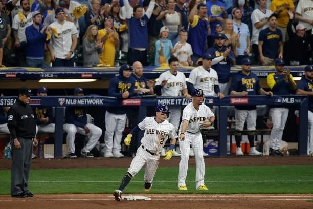 Luis Urias of the Milwaukee Brewers singles during game 2 of the National League Division Series at American Family Field on October 09, 2021 in...
