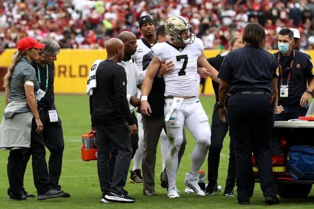 Taysom Hill of the New Orleans Saints is carted off the field during the first half against the Washington Football Team at FedExField on October 10,...