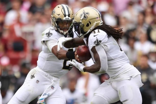 Jameis Winston of the New Orleans Saints hands the ball to Alvin Kamara during the first half against the Washington Football Team at FedExField on...