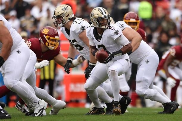 Jameis Winston of the New Orleans Saints looks to hand the ball during the first half against the Washington Football Team at FedExField on October...