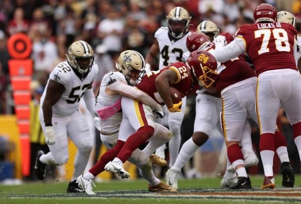 Antonio Gibson of the Washington Football Team is tackled during the first half against the New Orleans Saints at FedExField on October 10, 2021 in...