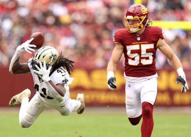 Alvin Kamara of the New Orleans Saints drops a pass as Cole Holcomb of the Washington Football Team defends during the second half at FedExField on...