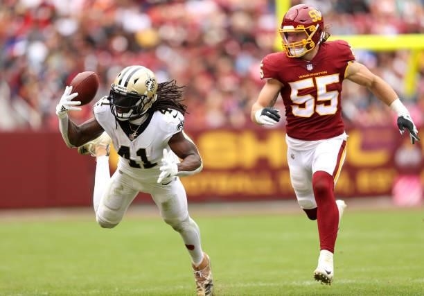Alvin Kamara of the New Orleans Saints drops a pass as Cole Holcomb of the Washington Football Team defends during the second half at FedExField on...