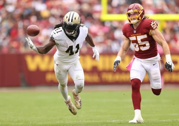 Alvin Kamara of the New Orleans Saints attempts to catch the ball as Cole Holcomb of the Washington Football Team defends during the second half at...