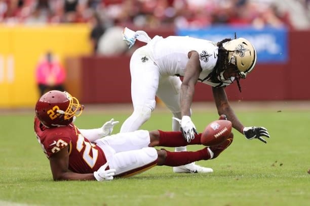 Alvin Kamara of the New Orleans Saints drops a pass a William Jackson of the Washington Football Team defends during the second half at FedExField on...