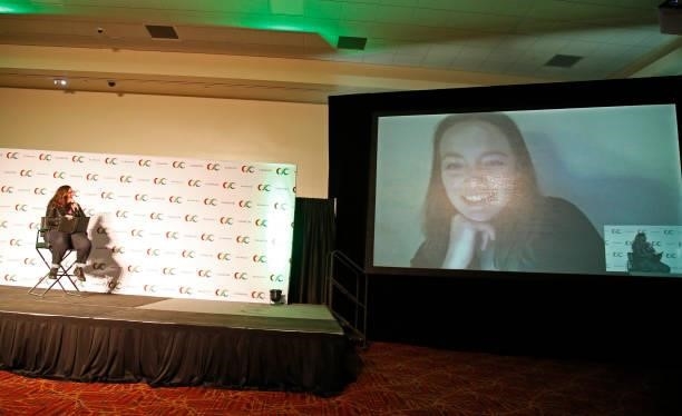 Queer Media Matters founder Dana Piccoli speaks with Amalia Holm who is displayed on a screen via videoconferencing software during the "Amalia Holm...