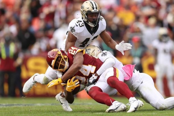 Antonio Gibson of the Washington Football Team is tackled by Marcus Williams of the New Orleans Saints during the second half at FedExField on...