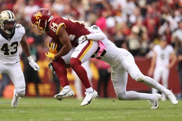 Antonio Gibson of the Washington Football Team is tackled during the second half against the New Orleans Saints at FedExField on October 10, 2021 in...