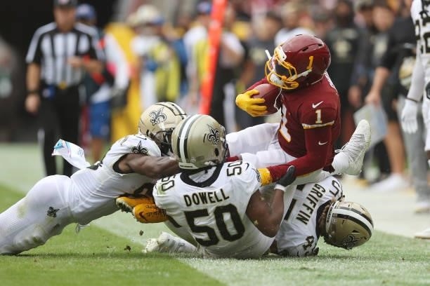 DeAndre Carter of the Washington Football Team is tackled by Andrew Dowell of the New Orleans Saints and Garrett Griffin during the second half at...