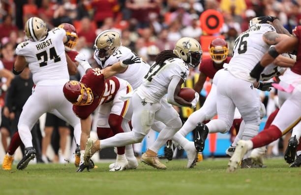 Alvin Kamara of the New Orleans Saints runs with the ball during the second half against the Washington Football Team at FedExField on October 10,...