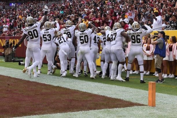 The New Orleans Saints celebrate a fourth quarter interception against the Washington Football Team at FedExField on October 10, 2021 in Landover,...