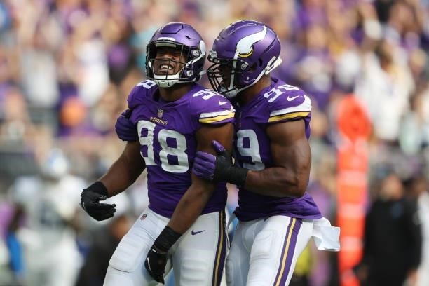 Wonnum and Danielle Hunter of the Minnesota Vikings celebrate after sacking Jared Goff of the Detroit Lions during the fourth quarter at U.S. Bank...