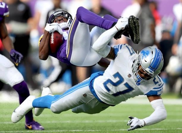 Dede Westbrook of the Minnesota Vikings is hit by Bobby Price of the Detroit Lions during a punt return in the fourth quarter at U.S. Bank Stadium on...