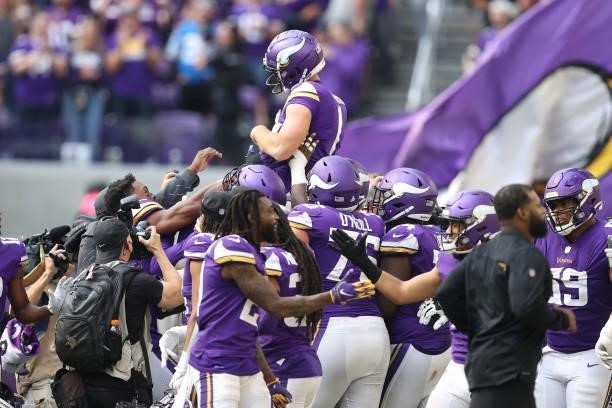 Greg Joseph of the Minnesota Vikings is carried off the field by teammates after kicking the game winning field goal against the Detroit Lions at...