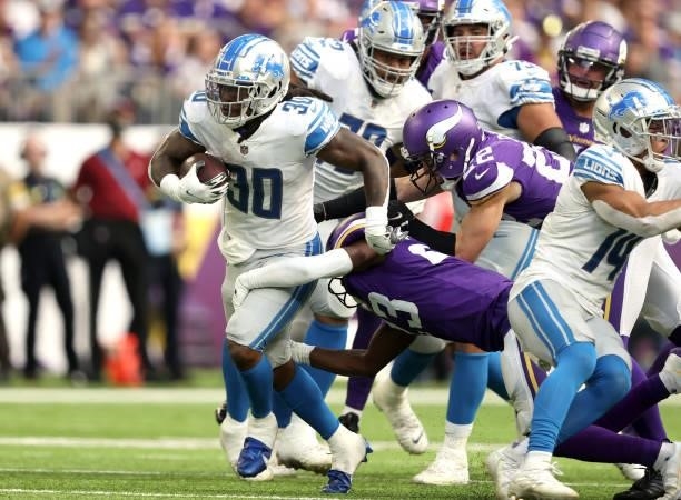 Jamaal Williams of the Detroit Lions runs the ball during the third quarter against the Minnesota Vikings at U.S. Bank Stadium on October 10, 2021 in...