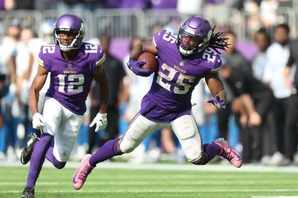 Alexander Mattison of the Minnesota Vikings runs the ball for a first down run during the second half at U.S. Bank Stadium on October 10, 2021 in...