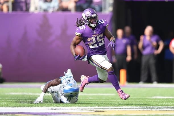 Alexander Mattison of the Minnesota Vikings runs the ball for a first down run during the second half at U.S. Bank Stadium on October 10, 2021 in...