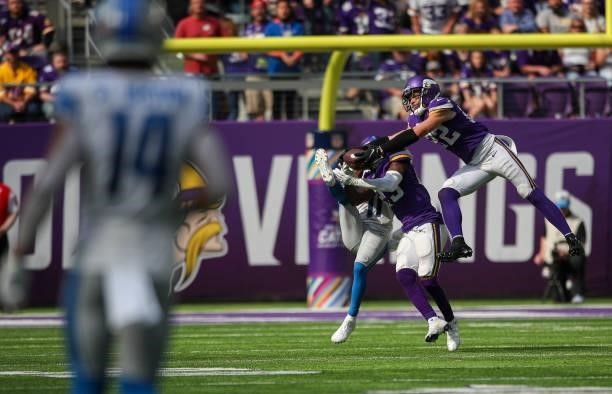 Xavier Woods and Harrison Smith of the Minnesota Vikings break up a pass intended for Kalif Raymond of the Detroit Lions during the third quarter at...