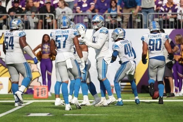 Detroit Lions celebrate after recovering a fumble during the fourth quarter against the Minnesota Vikings at U.S. Bank Stadium on October 10, 2021 in...