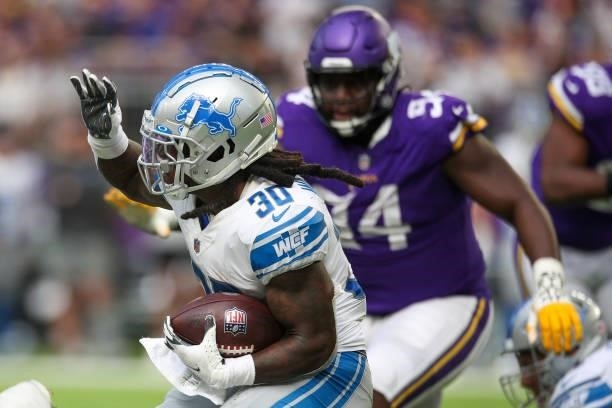 Jamaal Williams of the Detroit Lions runs the ball during the third quarter against the Minnesota Vikings at U.S. Bank Stadium on October 10, 2021 in...