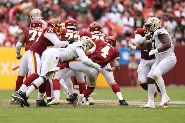Taylor Heinicke of the Washington Football Team is sacked by Carl Granderson of the New Orleans Saints during the second half at FedExField on...