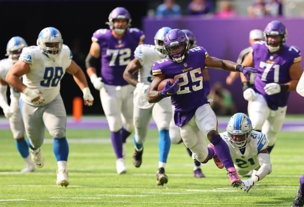 Alexander Mattison of the Minnesota Vikings runs the ball during the second half against the Detroit Lions at U.S. Bank Stadium on October 10, 2021...