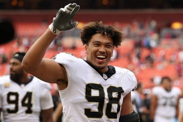 Payton Turner of the New Orleans Saints celebrates after a game against the Washington Football Team at FedExField on October 10, 2021 in Landover,...