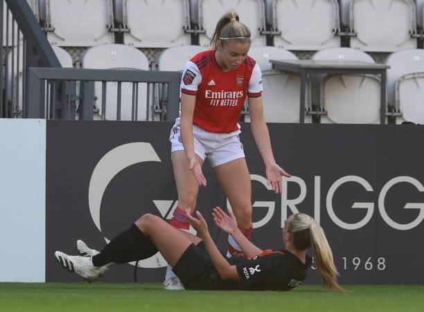 Leah Williamson of Arsenal helps up Toni Duggan of Everton during the Barclays FA Women's Super League match between Arsenal Women and Everton Women...