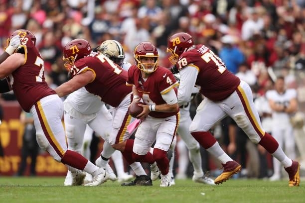 Taylor Heinicke of the Washington Football Team looks to hand off the ball during the second half against the New Orleans Saints at FedExField on...