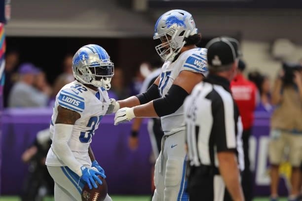 Andre Swift of the Detroit Lions celebrates a touchdown during the fourth quarter against the Minnesota Vikings at U.S. Bank Stadium on October 10,...