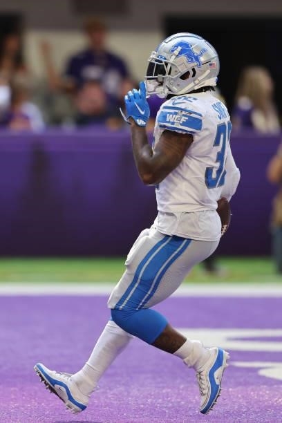 Andre Swift of the Detroit Lions scores a touchdown late in the fourth quarter against the Minnesota Vikings at U.S. Bank Stadium on October 10, 2021...