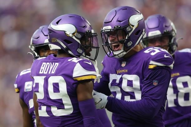 Nick Vigil of the Minnesota Vikings celebrates with Kris Boyd after a stop during the second half against the Detroit Lions at U.S. Bank Stadium on...